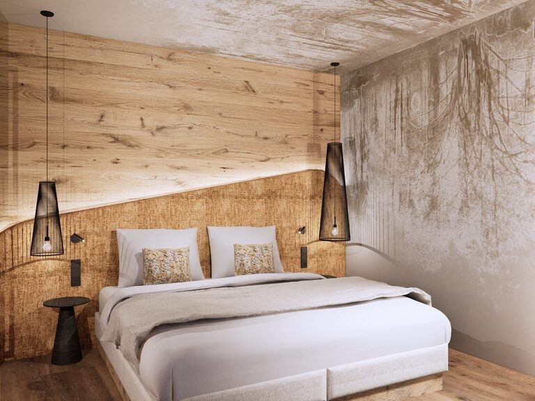 Ein geschmackvoll eingerichtetes Schlafzimmer mit weichem Bett in einer Suite des Hotel Tonihof, das moderne Akzente mit gemütlicher Atmosphäre im Bayerischen Wald vereint.